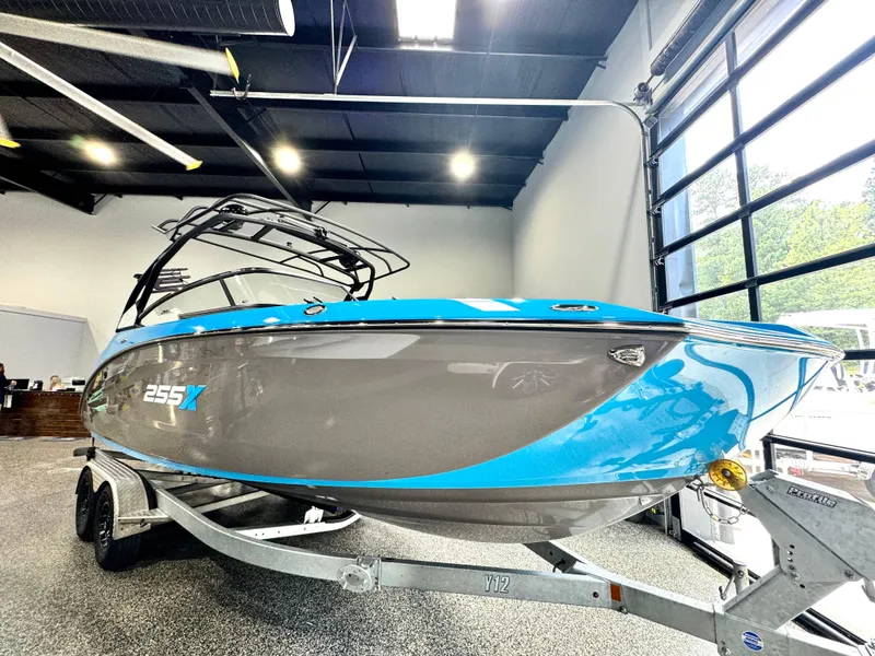 Slide: The Image of 2022 Yamaha Boats 255XD in showroom, blue and gray design on trailer. - 3