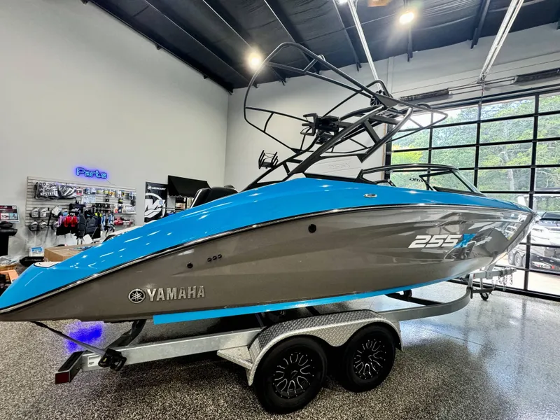 Slide: The Image of 2022 Yamaha Boats 255XD in showroom, blue and gray design on trailer. - 4