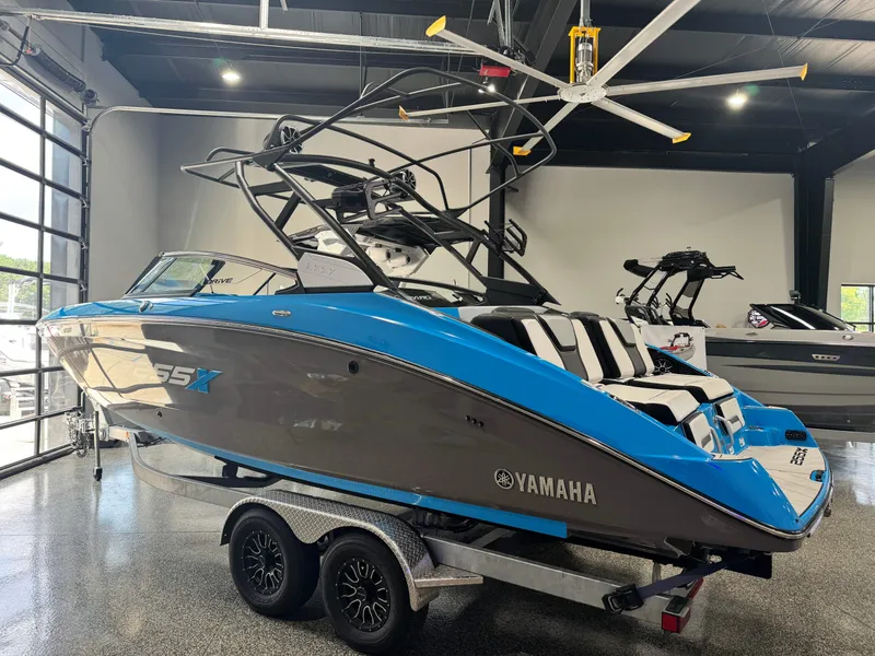 Slide: The Image of 2022 Yamaha Boats 255XD in showroom, blue and gray design, on trailer. - 5