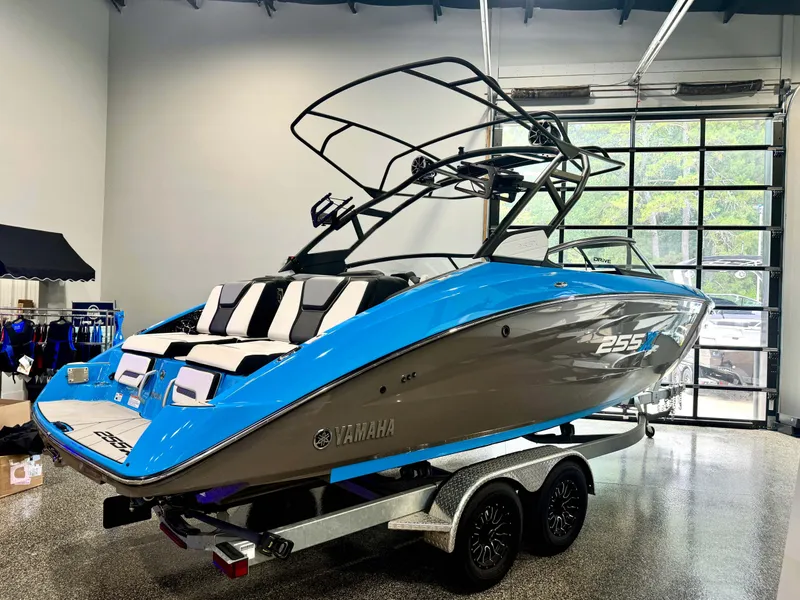 Slide: The Image of 2022 Yamaha Boats 255XD in showroom, blue and gray design on trailer. - 6