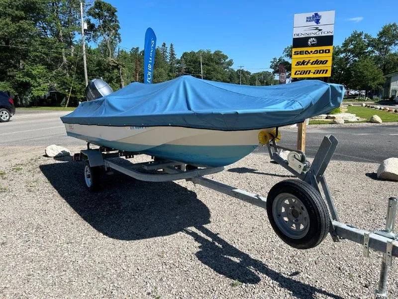 Slide: The Image of 1982 Boston Whaler Sport 15 boat on trailer with blue cover, parked outdoors. - 4