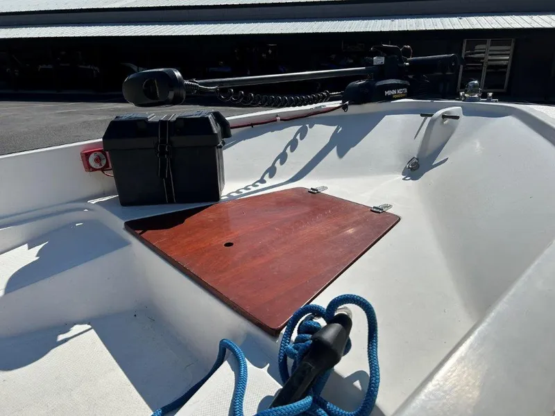 Slide: The Image of 1982 Boston Whaler Sport 15 boat interior with motor and blue rope. - 7