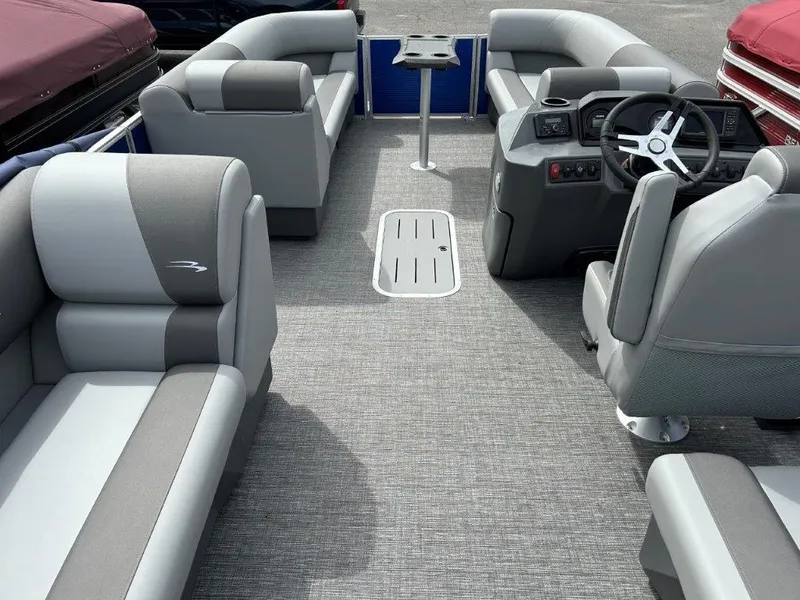 Slide: The Image of 2024 Bennington 20SVSRSPS pontoon boat interior with gray seating and steering console. - 10