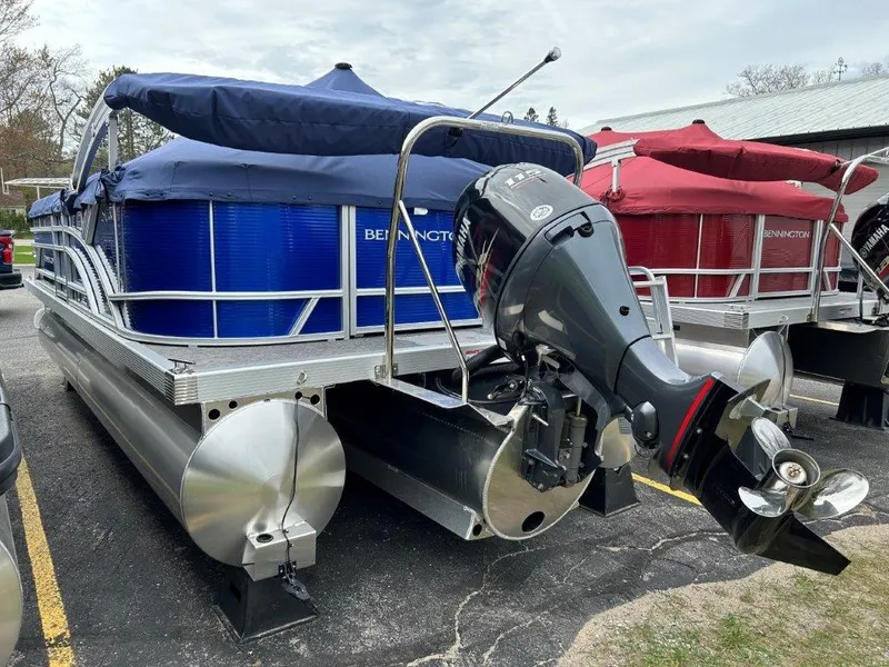 Slide: The Image of 2024 Bennington 20SVSRSPS pontoon boat with Yamaha outboard motor, blue and red covers. - 3