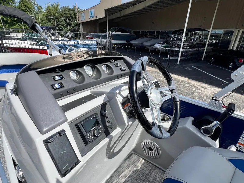 Slide: The Image of 2022 Bennington 23LSB boat dashboard with steering wheel and control panel. - 12