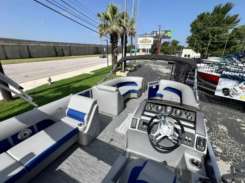 Slide: The Image of 2022 Bennington 23LSB pontoon boat interior with modern seating and steering console. - 20