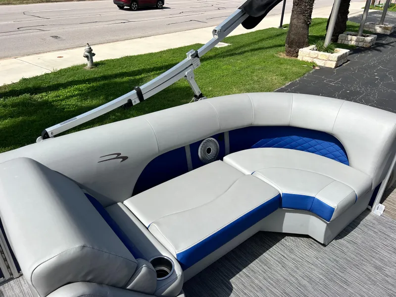 Slide: The Image of 2022 Bennington 23LSB boat interior with gray and blue seating. - 22