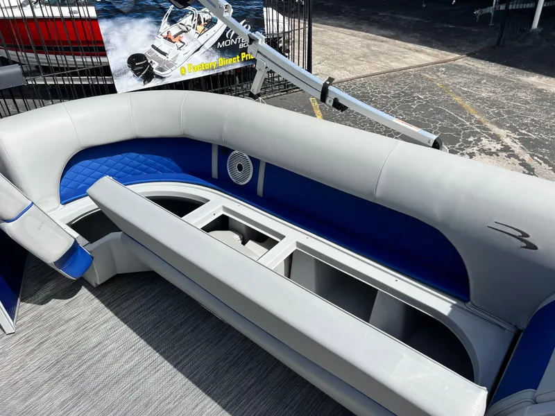Slide: The Image of 2022 Bennington 23LSB boat interior with blue and gray seating and storage compartments. - 23
