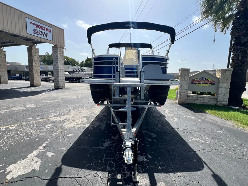 Slide: The Image of 2022 Bennington 23LSB pontoon boat on trailer at dealership. - 5