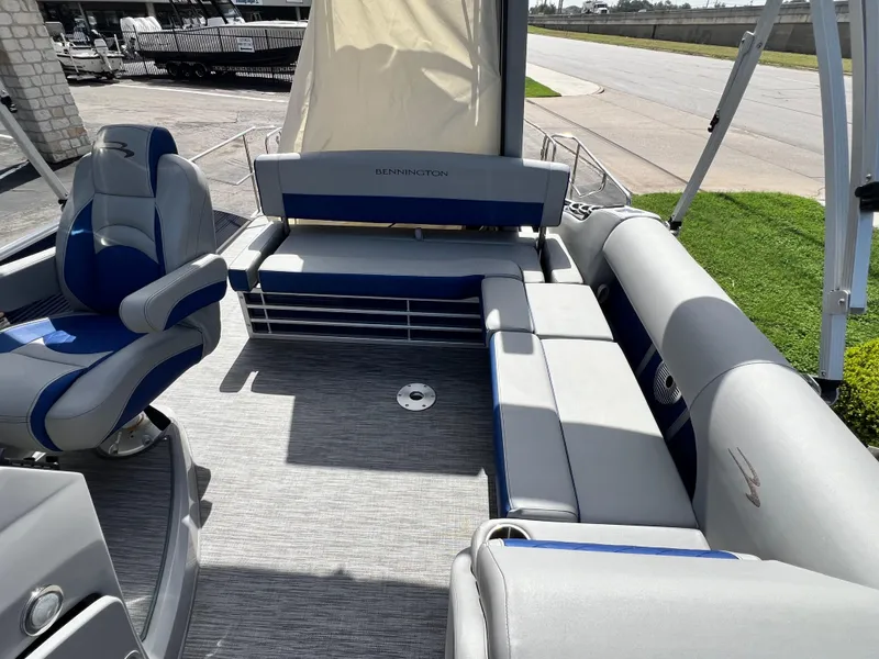 Slide: The Image of 2022 Bennington 23LSB pontoon boat interior with gray and blue seating. - 8
