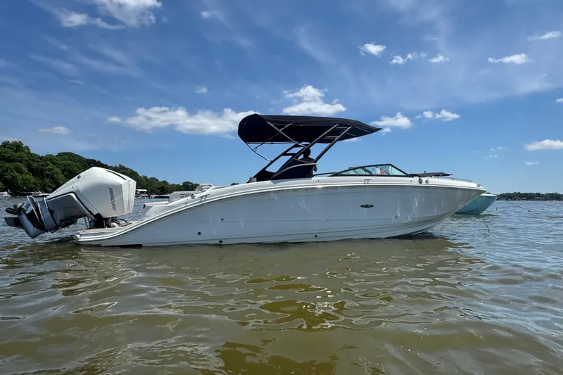 The Image of 2023 Sea Ray SDX 290 Outboard boat on calm water under blue sky. - 0