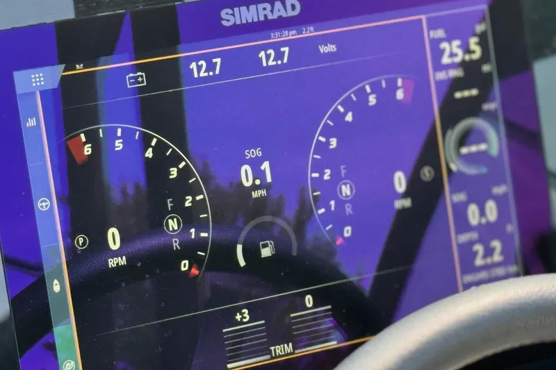 Slide: The Image of Simrad display on 2023 Sea Ray SDX 290 Outboard showing speed and RPM gauges. - 11