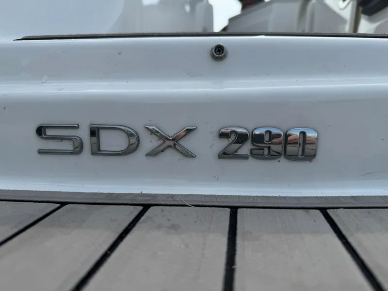 Slide: The Image of 2023 Sea Ray SDX 290 Outboard boat emblem on deck. - 12