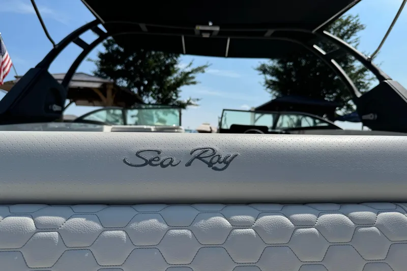 Slide: The Image of 2023 Sea Ray SDX 290 Outboard boat interior with logo and hexagonal pattern upholstery. - 18