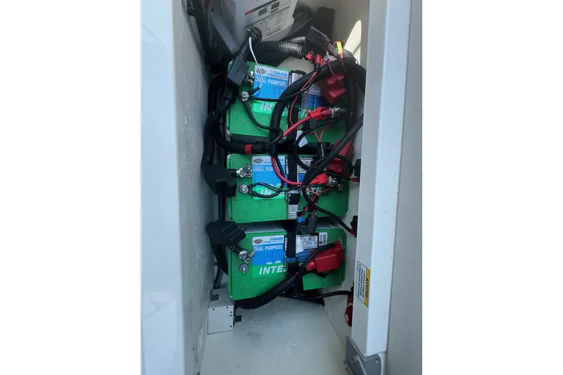 Slide: The Image of 2023 Sea Ray SDX 290 Outboard battery compartment with dual-purpose batteries. - 23