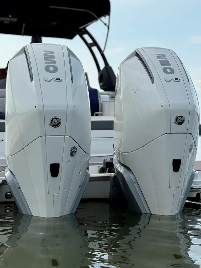 Slide: The Image of 2023 Sea Ray SDX 290 Outboard engines on water, showcasing powerful V8 design. - 7