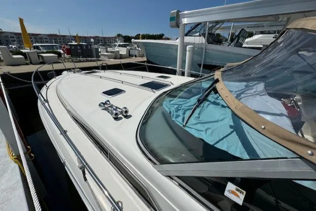 Slide: The Image of 1990 Sea Ray 350 Sundancer docked at marina under clear blue sky. - 20