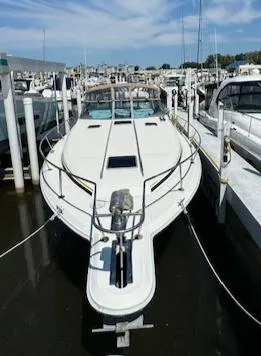 Slide: The Image of 1990 Sea Ray 350 Sundancer docked at marina under clear skies. - 26