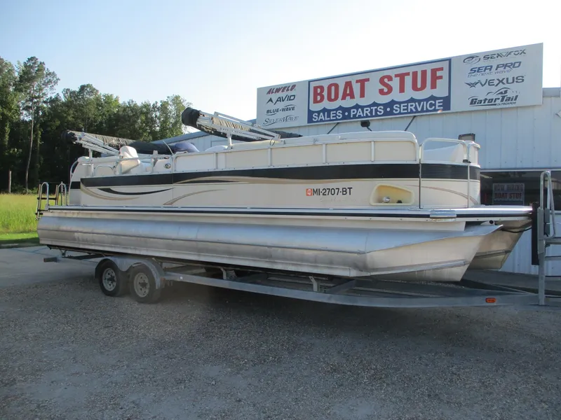Slide: The Image of 2007 Avalon Excalibur 27' pontoon boat on trailer at dealership. - 1