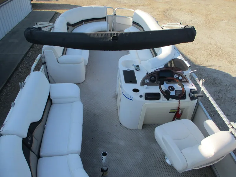 Slide: The Image of 2007 Avalon Excalibur 27' pontoon boat interior with white seating and steering console. - 14