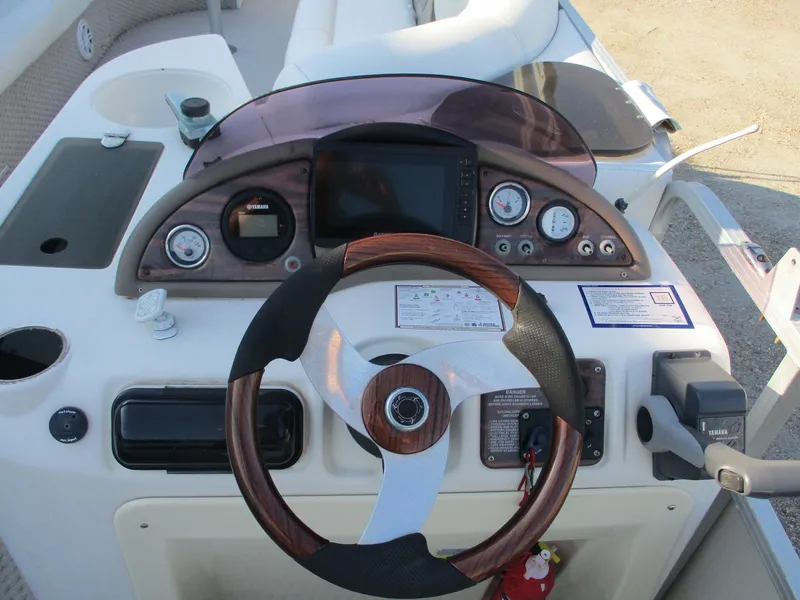 Slide: The Image of 2007 Avalon Excalibur boat dashboard with steering wheel and control panel. - 15