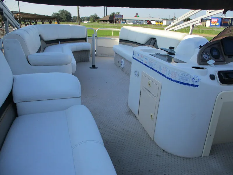 Slide: The Image of 2007 Avalon Excalibur 27' boat interior with white seating and control panel. - 19