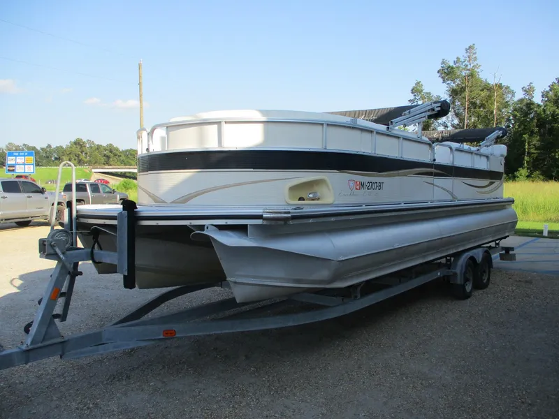Slide: The Image of 2007 Avalon Excalibur 27' pontoon boat on trailer, parked outdoors. - 3