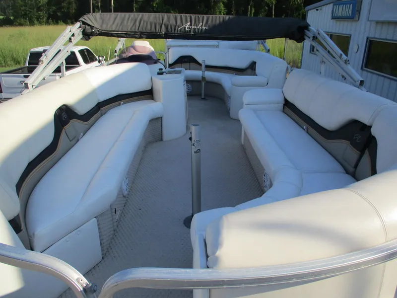 Slide: The Image of 2007 Avalon Excalibur 27' pontoon boat with spacious white seating and canopy. - 8