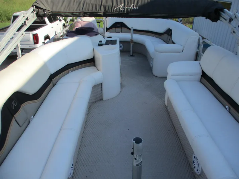 Slide: The Image of 2007 Avalon Excalibur 27' boat interior with white seating and canopy. - 9