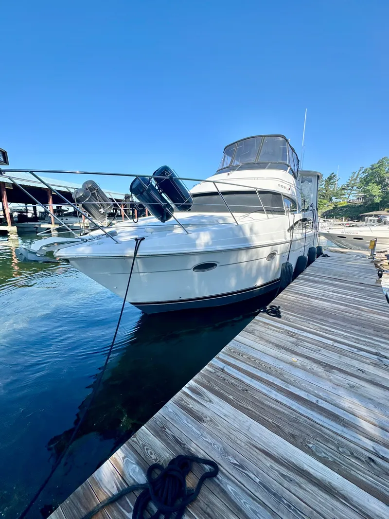 Slide: The Image of 2000 Carver 396 Motor Yacht docked at a marina under clear blue skies. - 1
