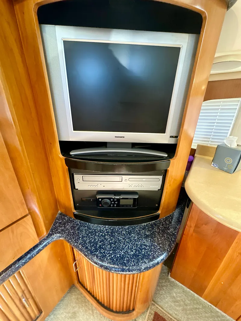 Slide: The Image of Entertainment center in 2000 Carver 396 Motor Yacht with TV and media equipment. - 14