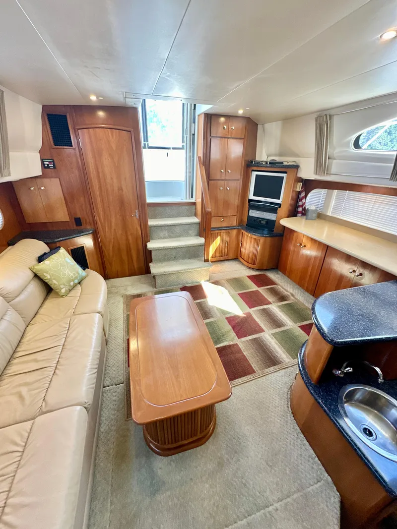 Slide: The Image of Interior of 2000 Carver 396 Motor Yacht with cozy seating and modern amenities. - 16