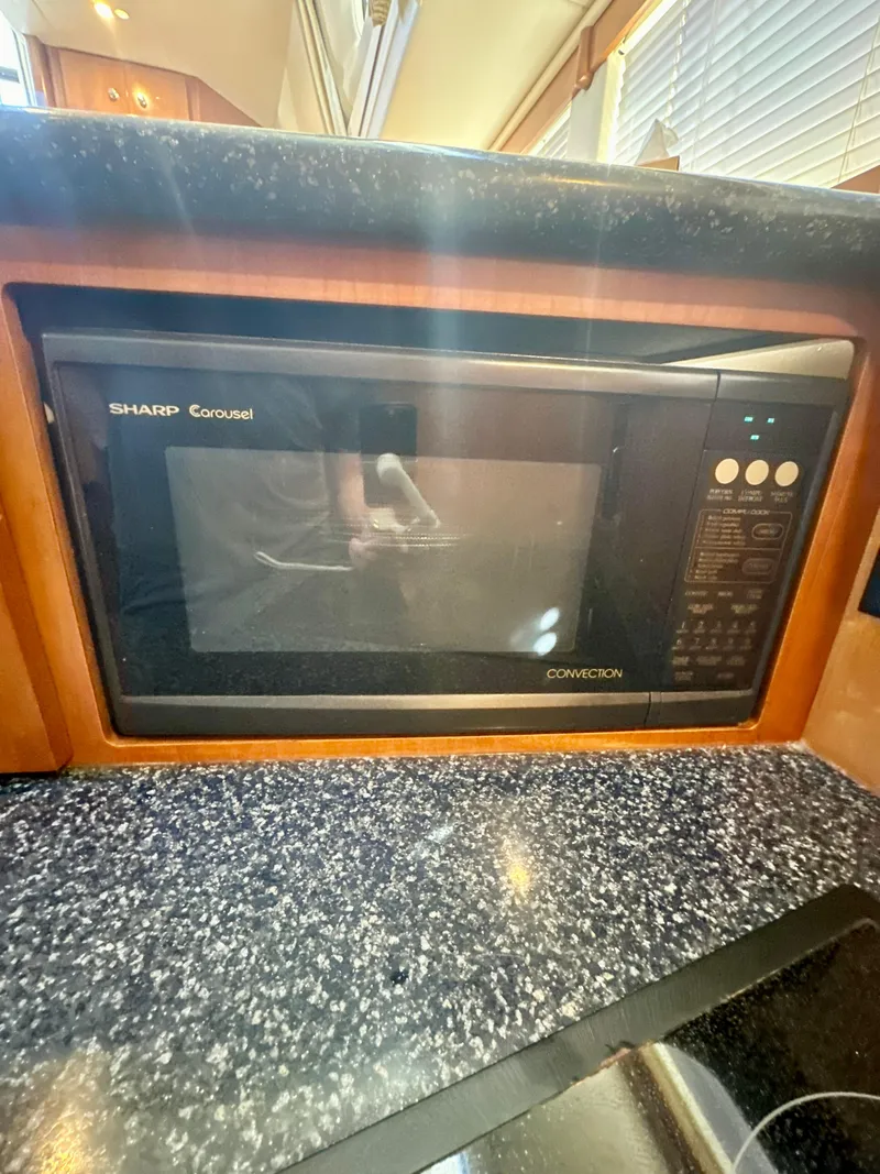 Slide: The Image of Microwave in 2000 Carver 396 Motor Yacht kitchen with granite countertop. - 18