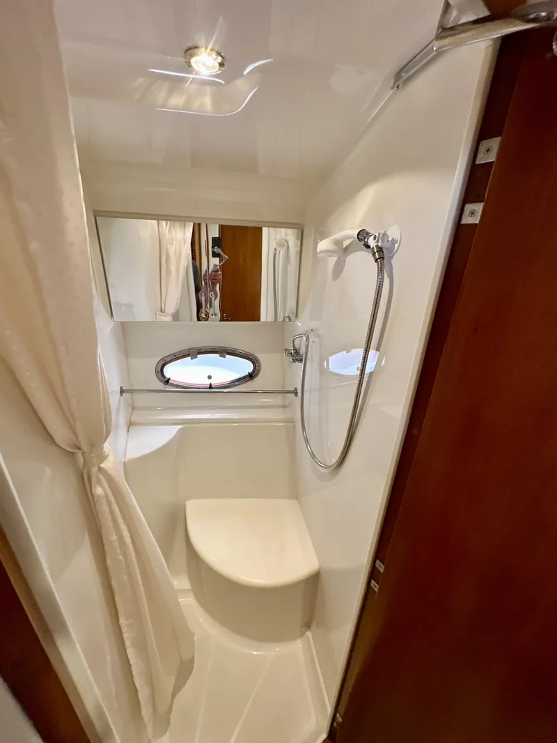 Slide: The Image of Compact bathroom in 2000 Carver 396 Motor Yacht with shower and porthole window. - 23