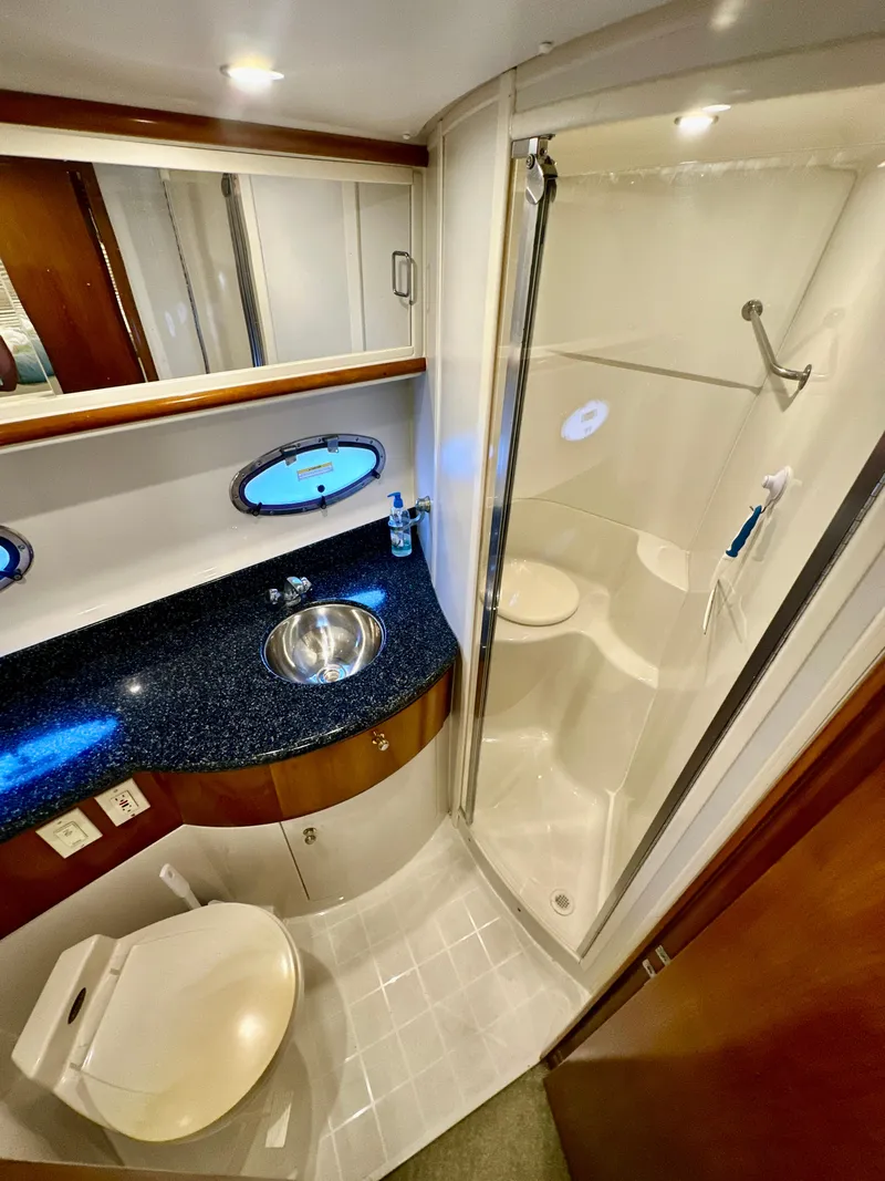 Slide: The Image of 2000 Carver 396 Motor Yacht bathroom with shower, sink, and toilet. - 28