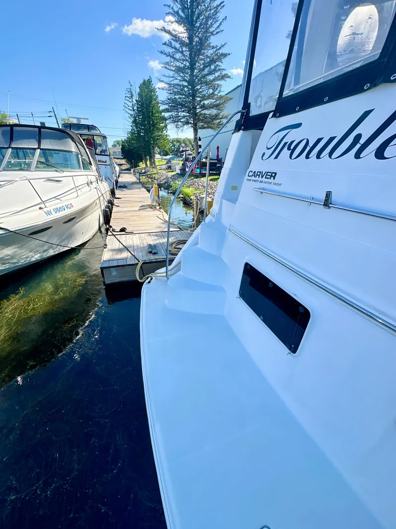 Slide: The Image of 2000 Carver 396 Motor Yacht docked, sunny day, clear sky, marina setting. - 3