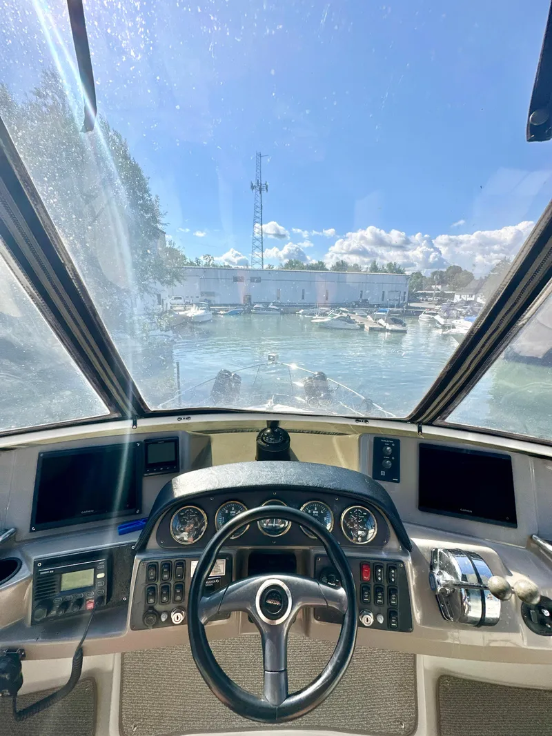 Slide: The Image of Interior view of 2000 Carver 396 Motor Yacht cockpit with steering wheel and control panels. - 10