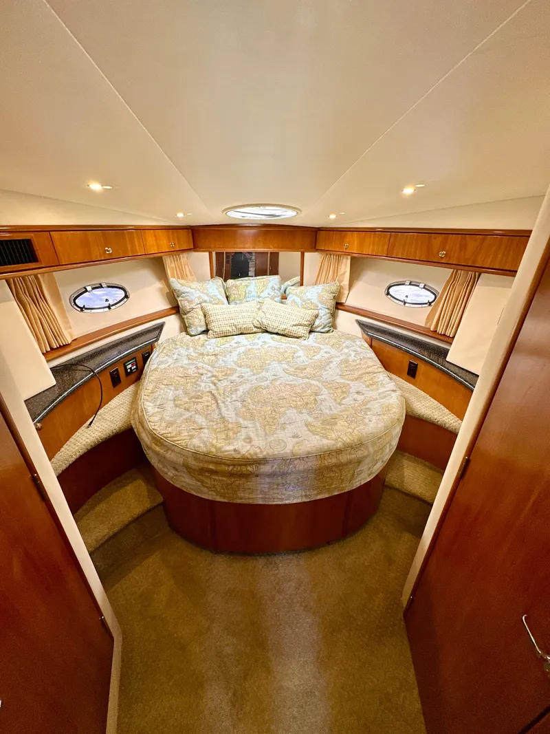 Slide: The Image of Interior of 2000 Carver 396 Motor Yacht with cozy bed and wooden cabinetry. - 22