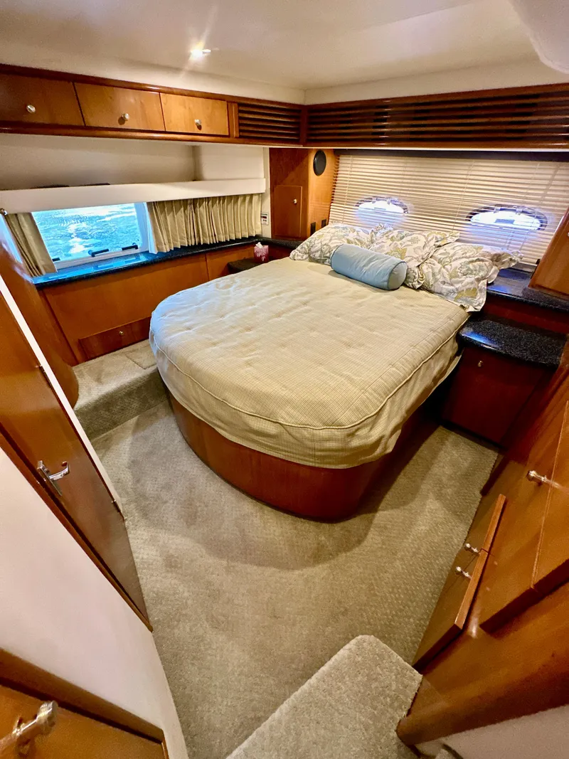 Slide: The Image of Luxurious bedroom in 2000 Carver 396 Motor Yacht with cozy bed and elegant wood finishes. - 27