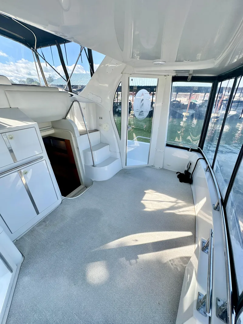Slide: The Image of 2000 Carver 396 Motor Yacht interior with carpeted floor and panoramic windows. - 5
