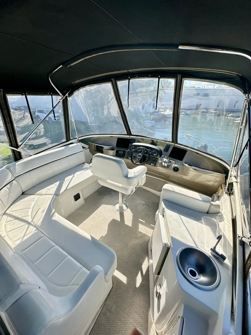 Slide: The Image of 2000 Carver 396 Motor Yacht interior with helm, seating, and panoramic windows. - 7