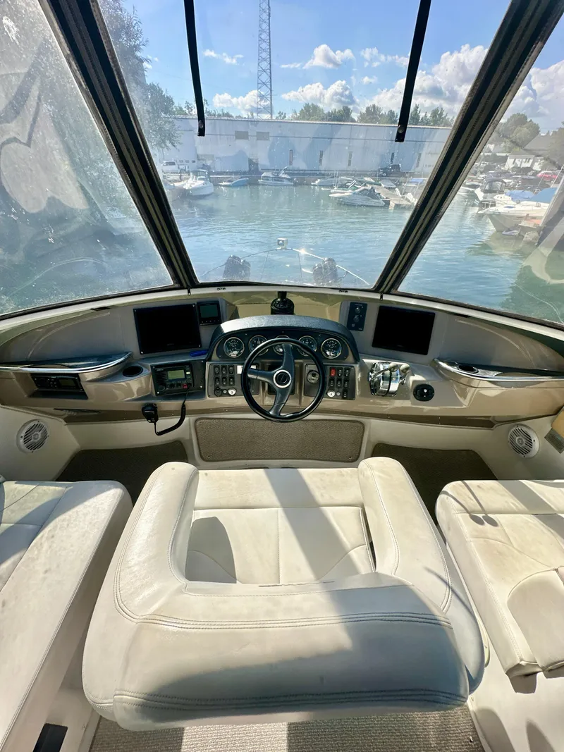 Slide: The Image of 2000 Carver 396 Motor Yacht helm with dual screens and panoramic view. - 8