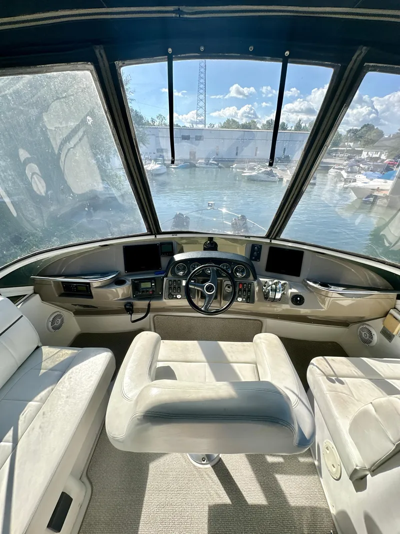 Slide: The Image of Interior view of 2000 Carver 396 Motor Yacht cockpit with steering wheel and navigation controls. - 9