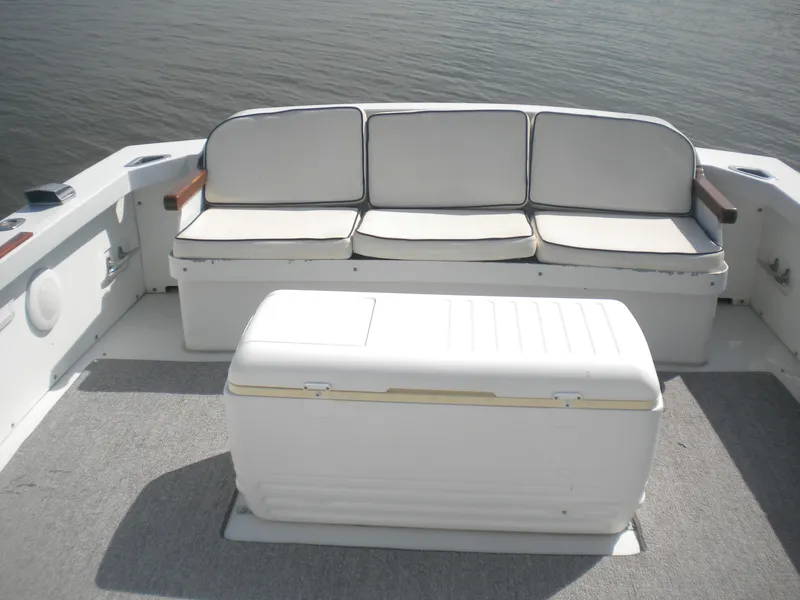 Slide: The Image of 1968 Bertram 31 Bahia Mar boat interior with cushioned seating and storage box. - 10