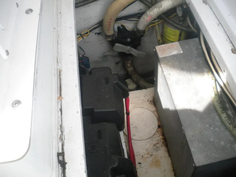 Slide: The Image of Engine compartment of a 1968 Bertram 31 Bahia Mar boat, showing batteries and wiring. - 11