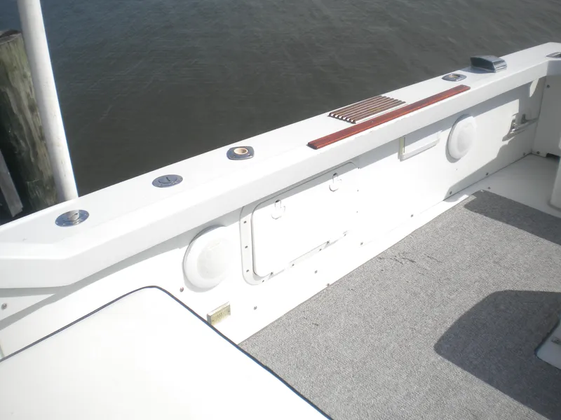 Slide: The Image of 1968 Bertram 31 Bahia Mar boat deck with white seating and gray flooring. - 12