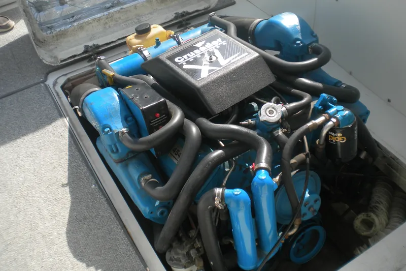 Slide: The Image of Engine of a 1968 Bertram 31 Bahia Mar boat, featuring blue components and black hoses. - 22
