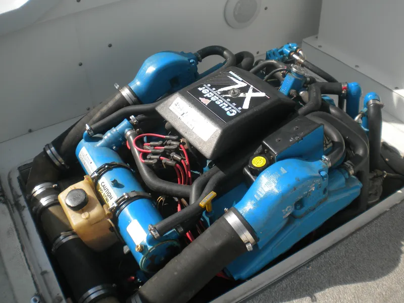 Slide: The Image of Engine of a 1968 Bertram 31 Bahia Mar boat, featuring blue components and wiring. - 23