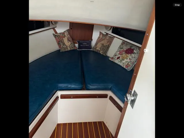 Slide: The Image of 1968 Bertram 31 Bahia Mar cabin interior with blue cushions and decorative pillows. - 29