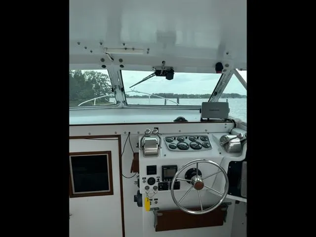 Slide: The Image of Interior view of a 1968 Bertram 31 Bahia Mar boat cockpit with steering wheel and controls. - 33